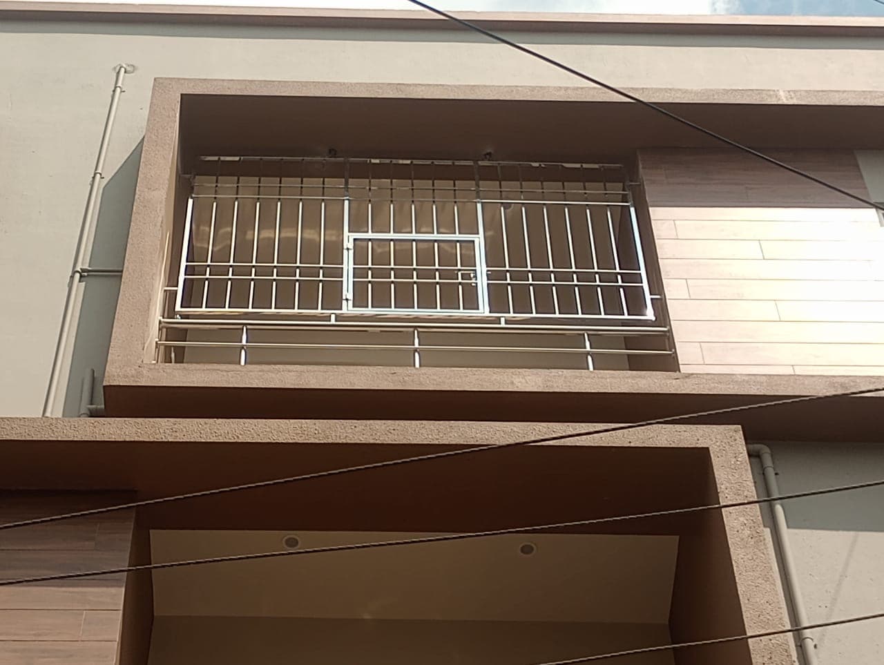 Modern stainless steel balcony safety grill installed in a high-rise apartment